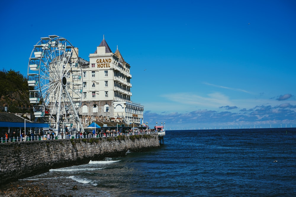 a ferris wheel on a pier next to a building