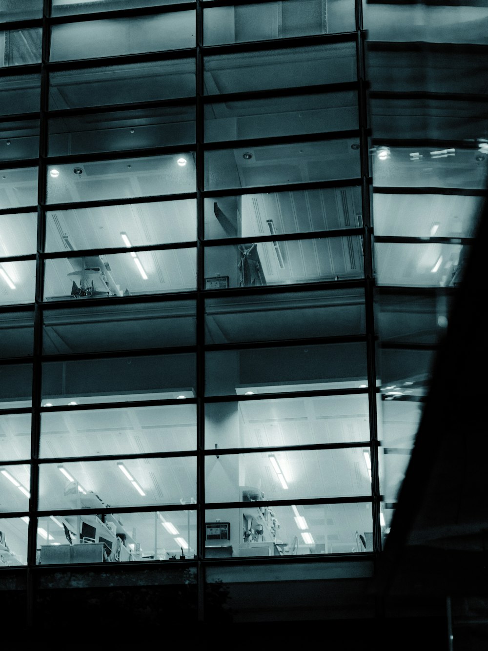 a tall building with lots of windows at night