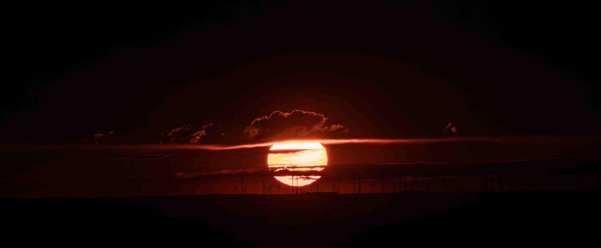 the sun setting over a body of water