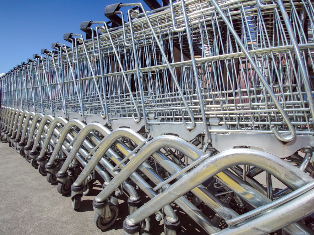 a row of metal carts sitting next to each other