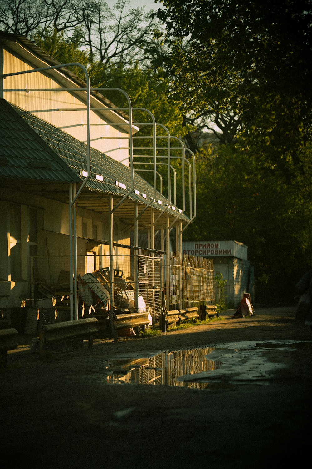 a truck parked next to a building near a forest