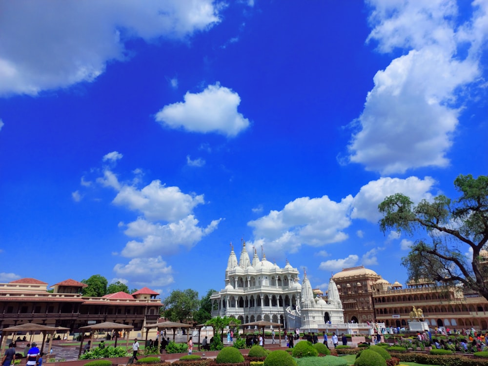 a large white building with a blue sky in the background