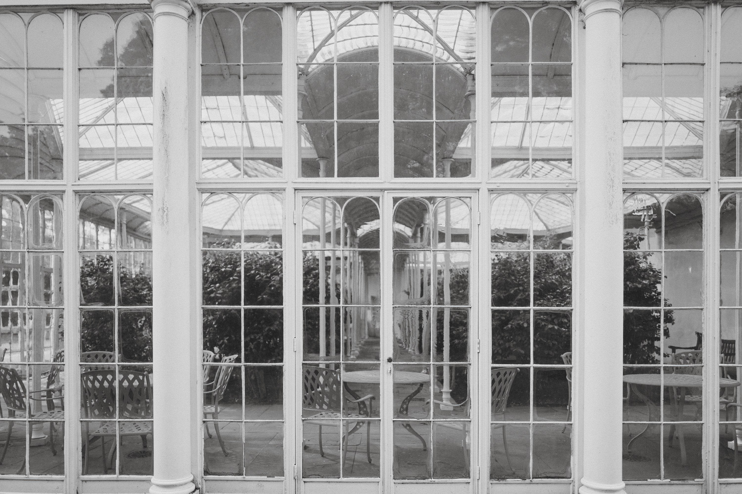 a black and white photo of a glass house