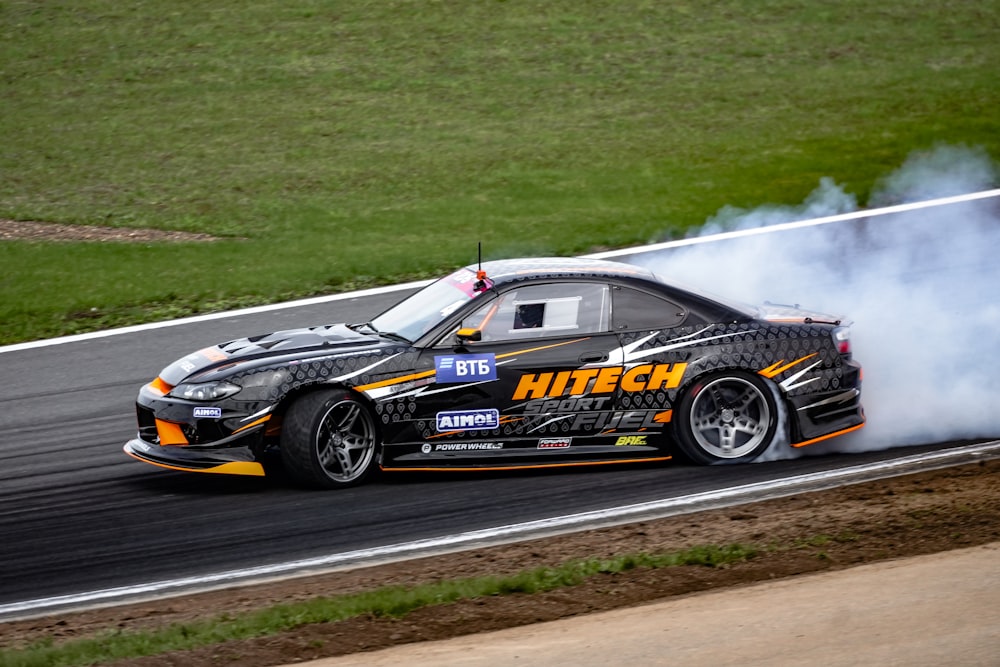 a car with smoke coming out of it driving on a track