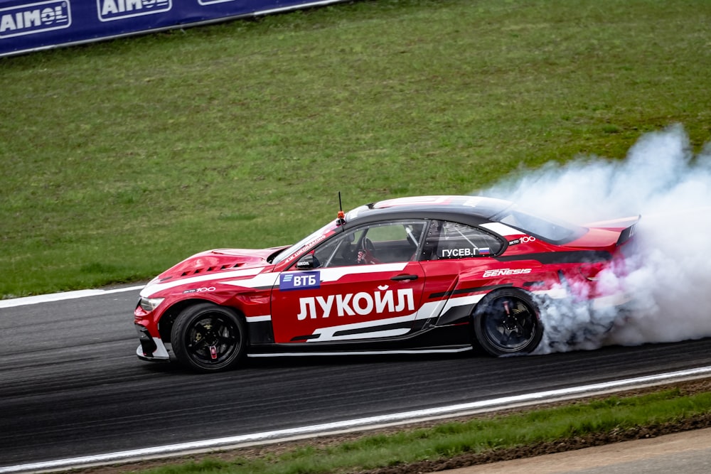 a red and white car with smoke coming out of it