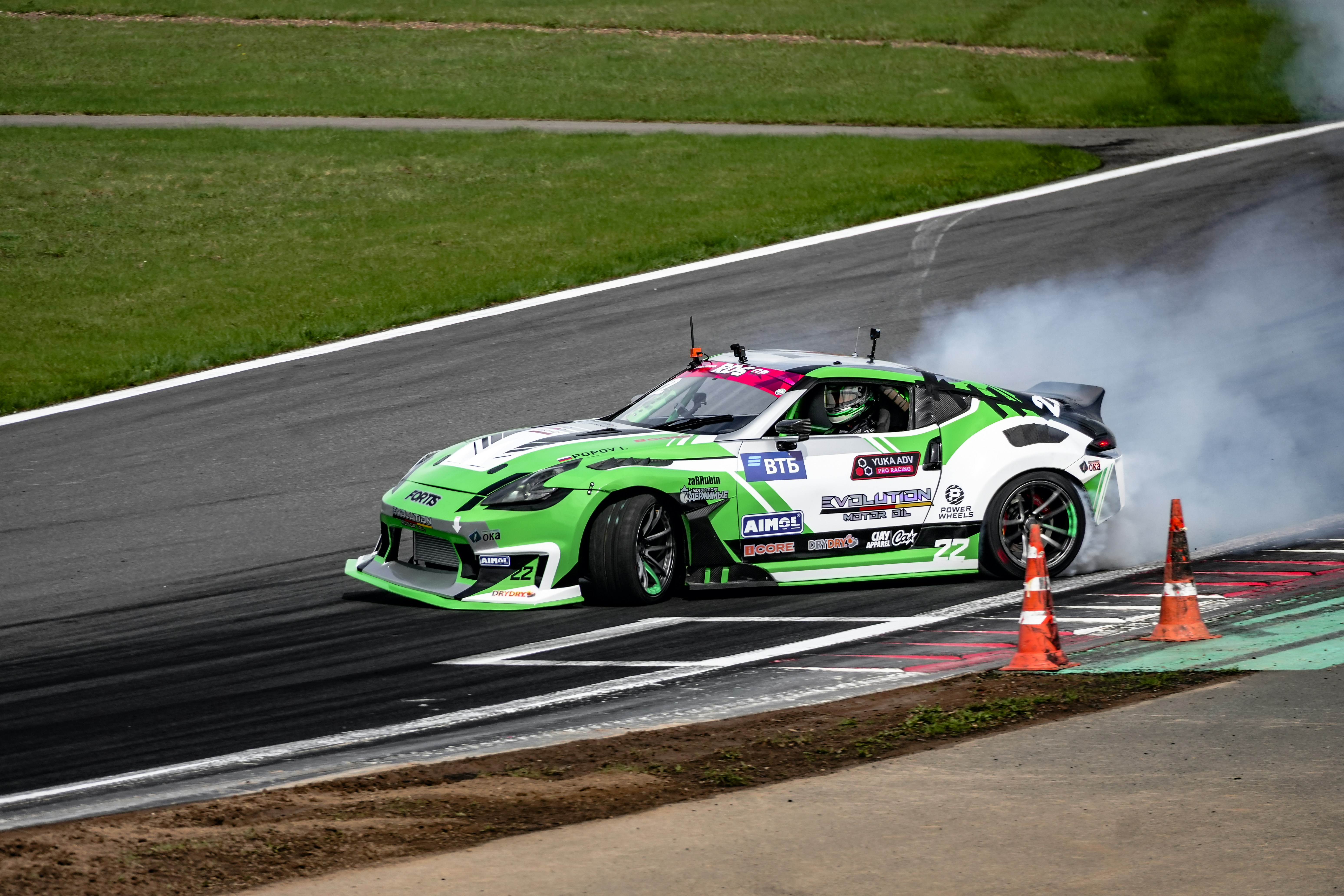 a green and white car on a race track