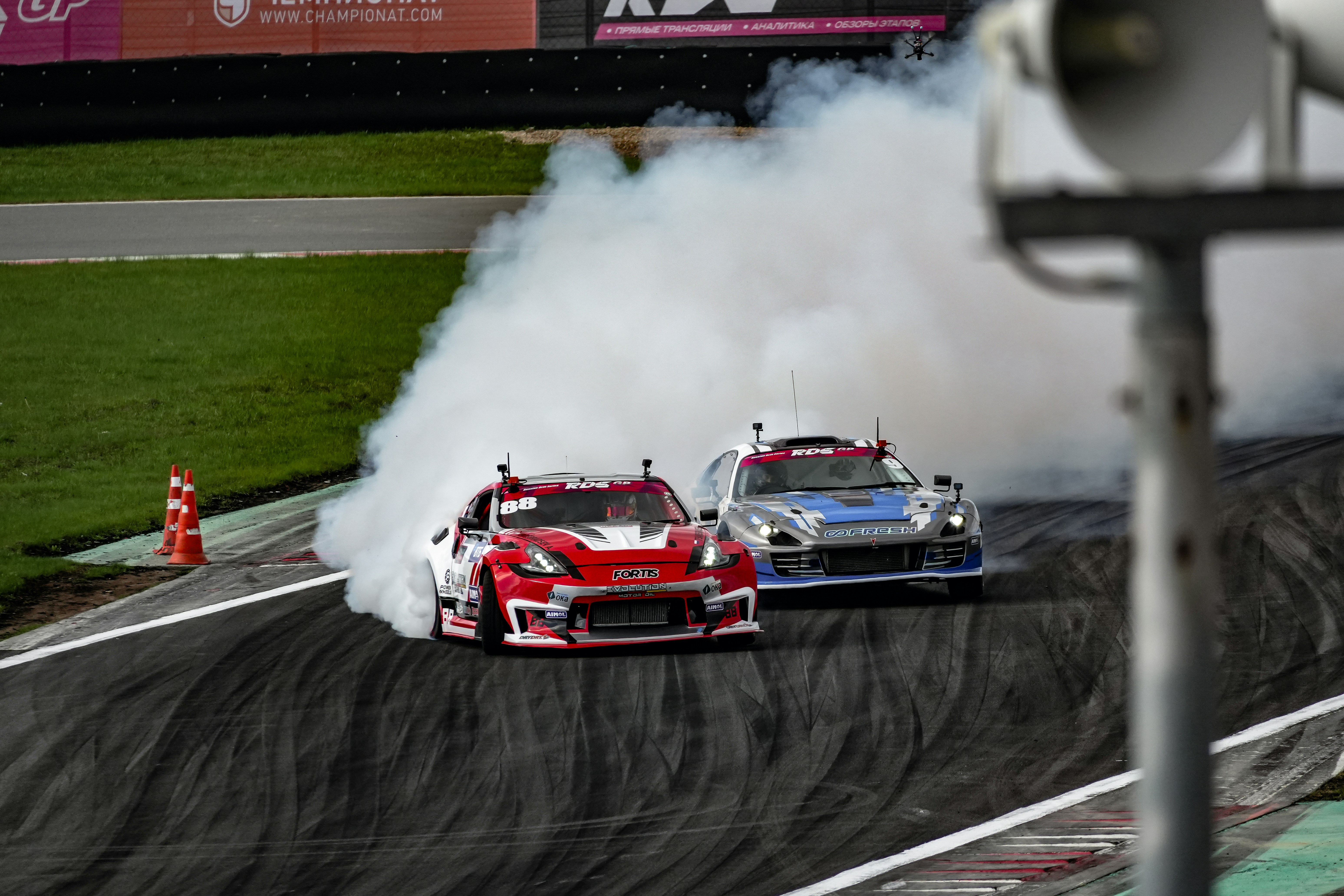 a couple of cars that are on a race track