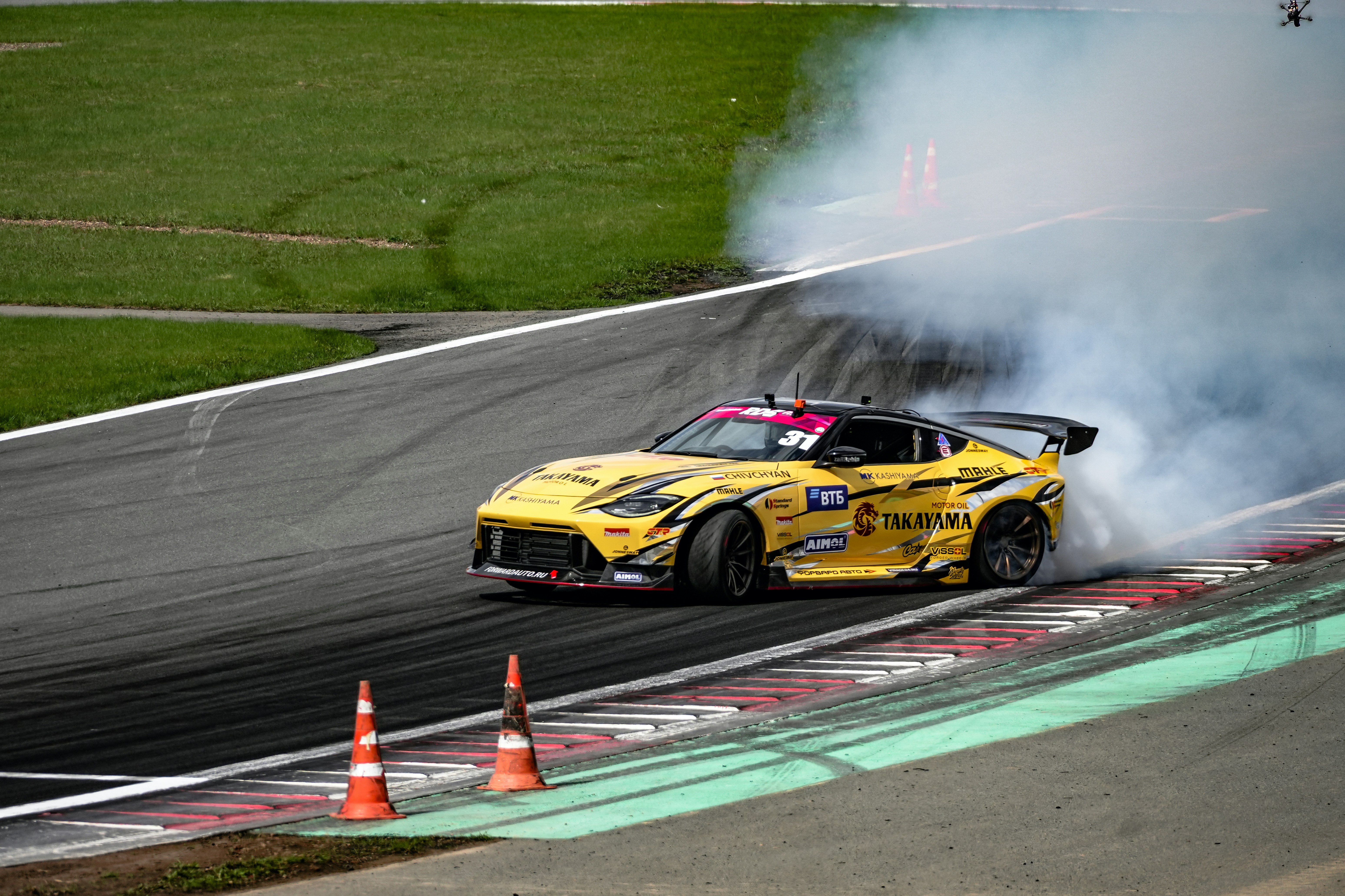 a yellow race car with smoke coming out of it