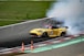a yellow race car with smoke coming out of it