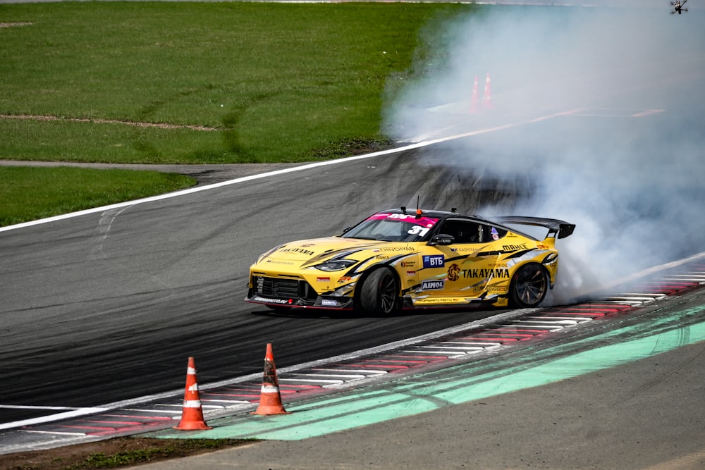 a yellow race car with smoke coming out of it