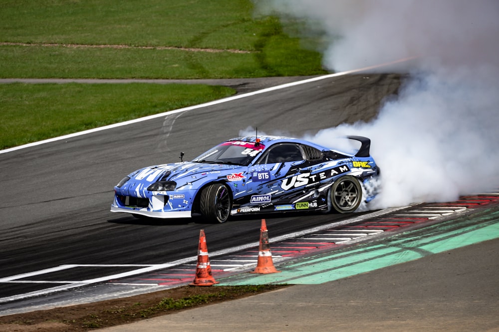 a blue car with smoke coming out of it