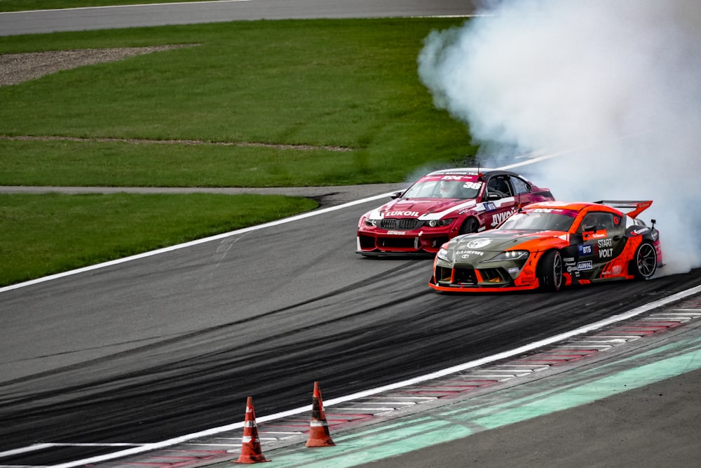 a couple of cars that are on a race track