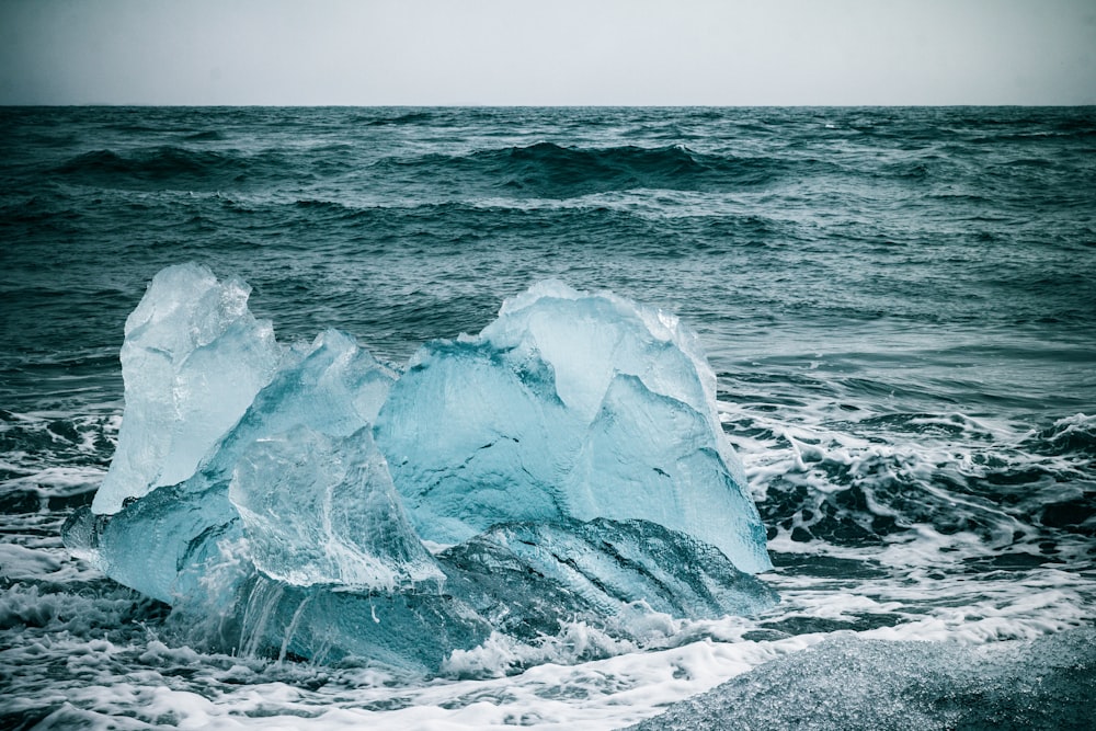 a large iceberg floating on top of a body of water