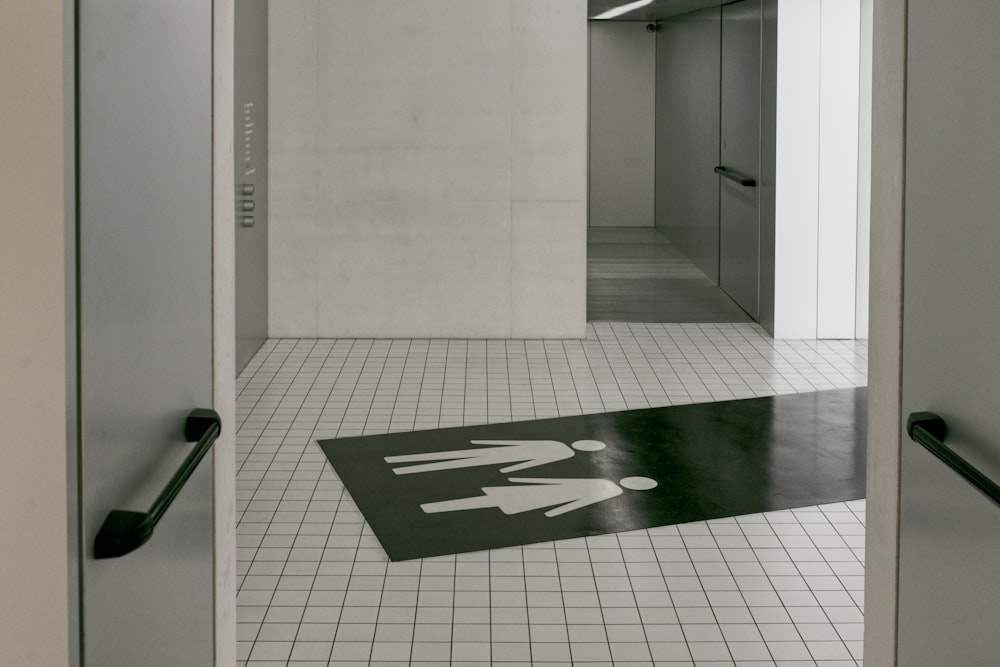 a black and white photo of a restroom floor