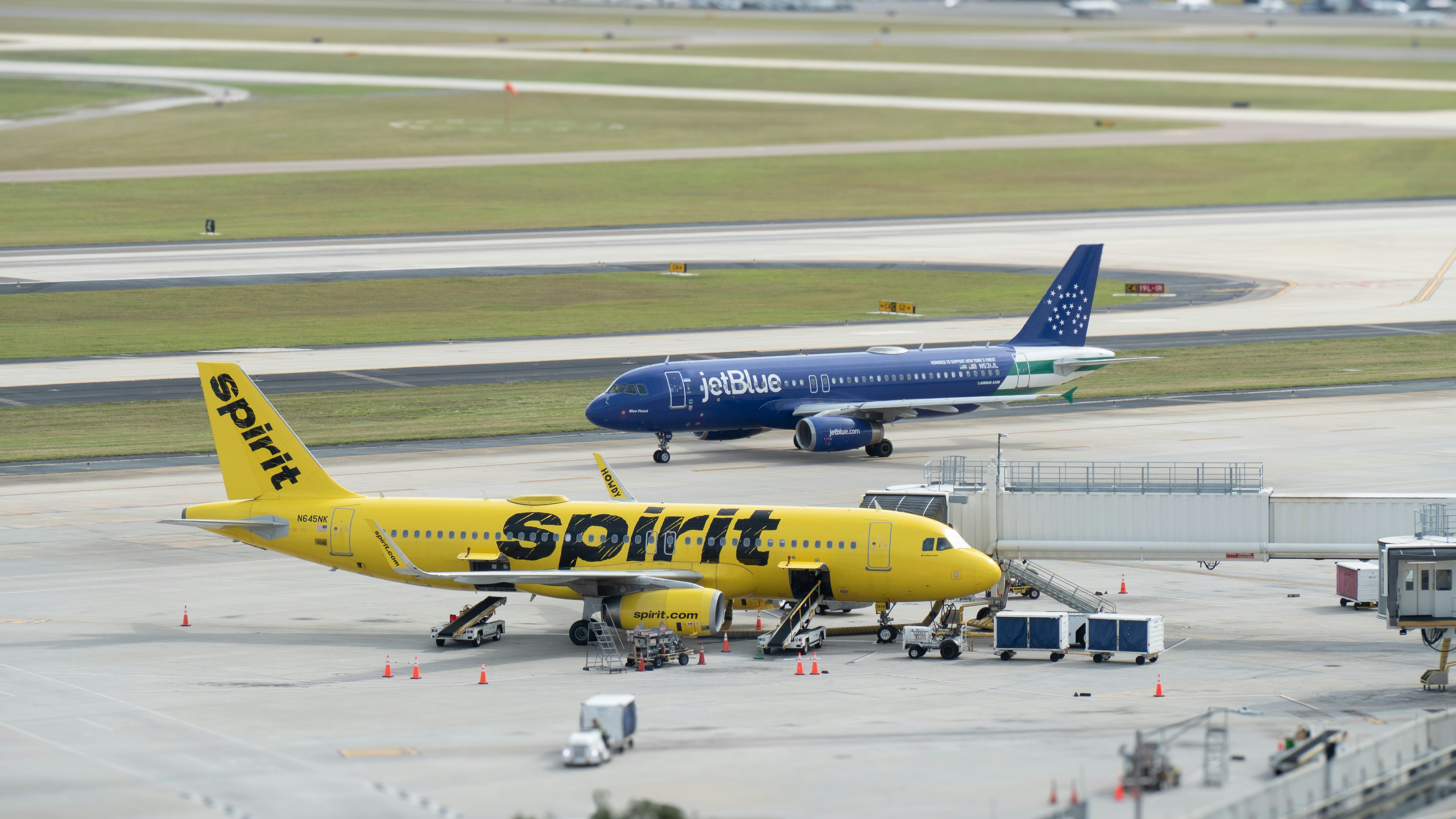 a yellow and blue jet airliner sitting on top of an airport tarmac, 