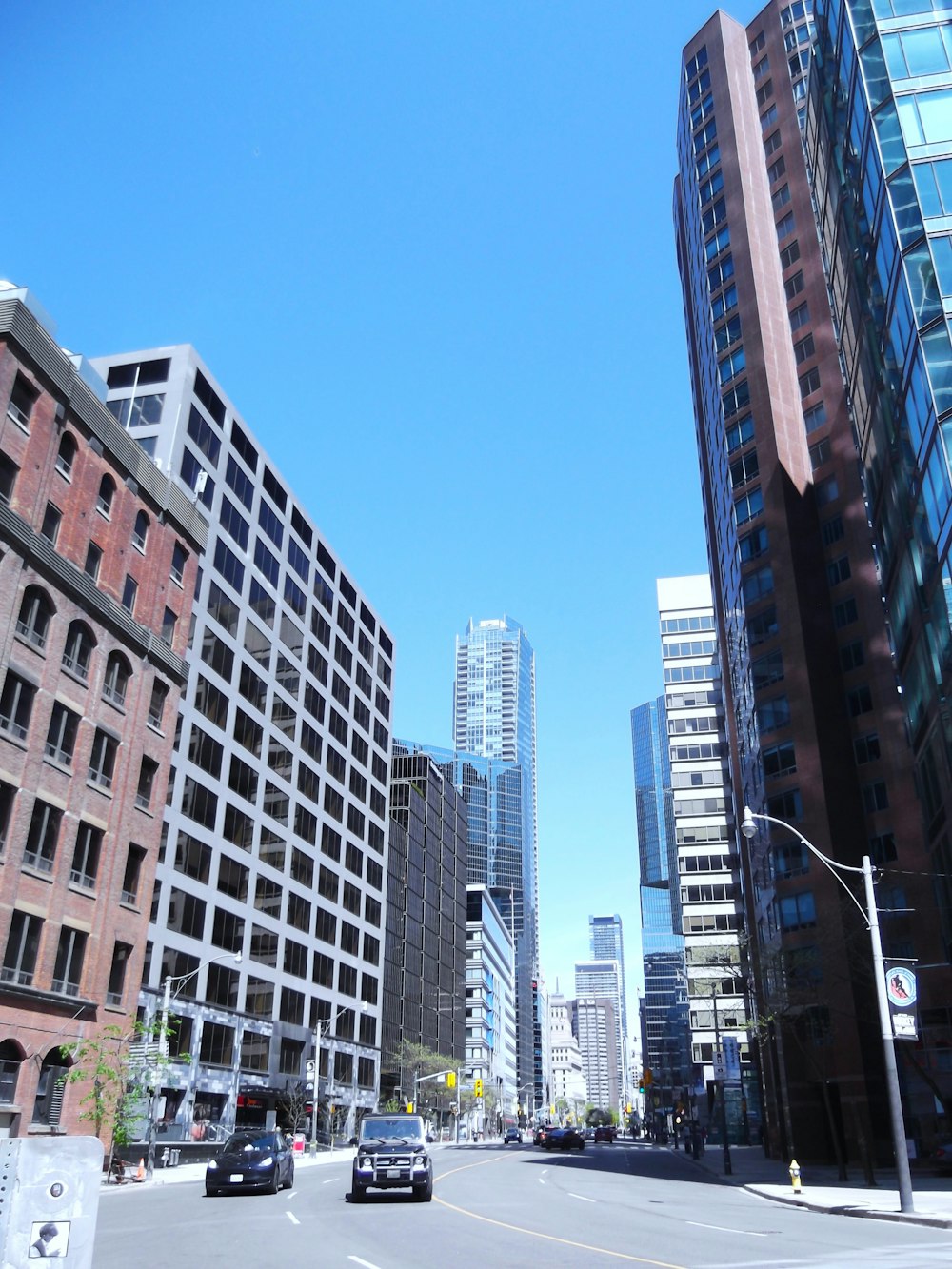 a city street lined with tall buildings and tall skyscrapers