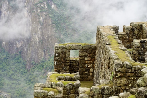 a stone structure with moss growing on it