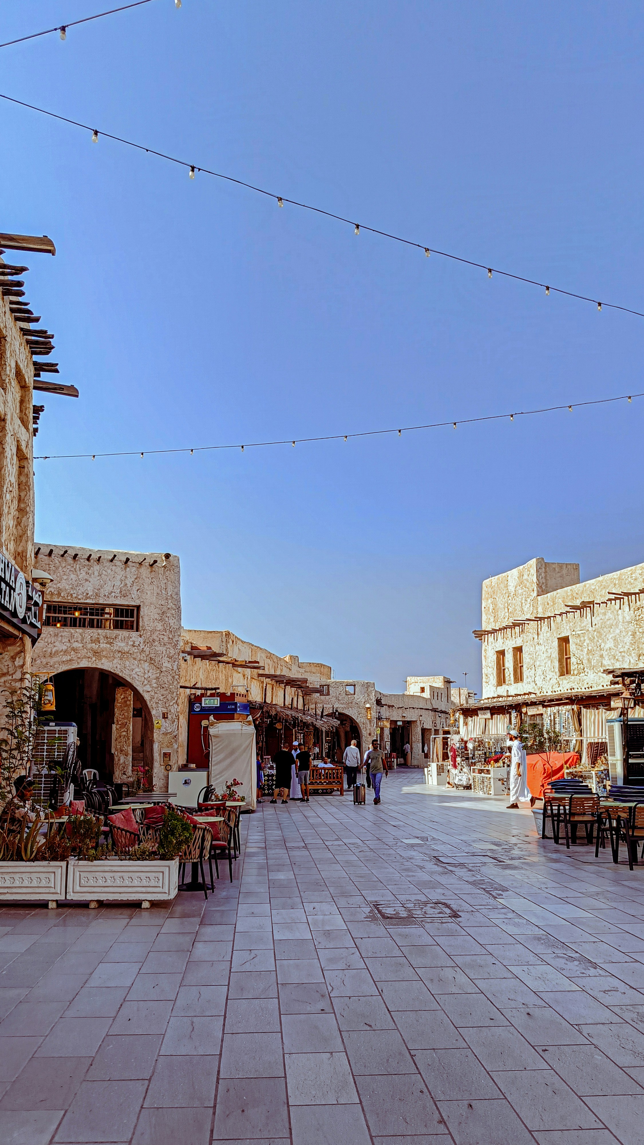 an empty street with tables and chairs on it