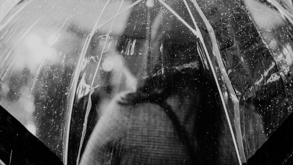 a black and white photo of a person holding an umbrella
