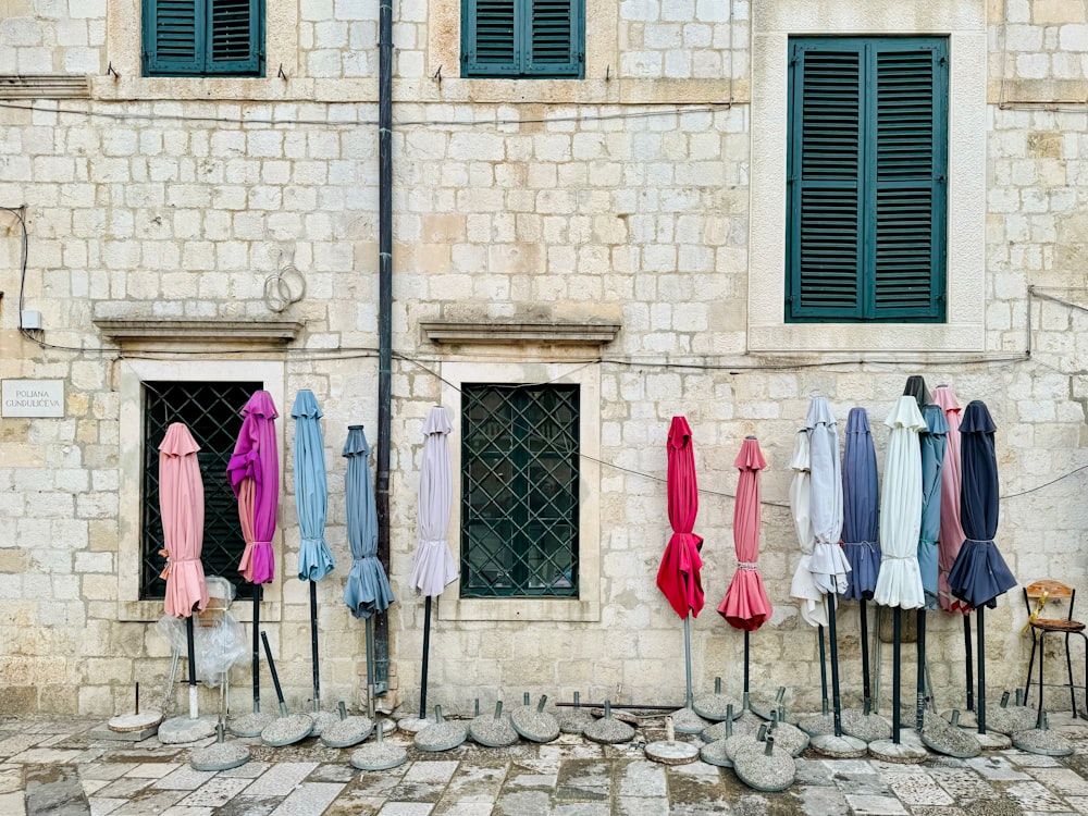 a row of umbrellas are hanging outside of a building