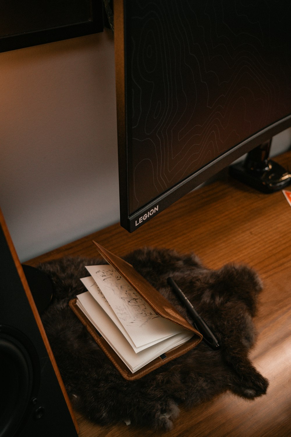 a computer monitor sitting on top of a wooden desk