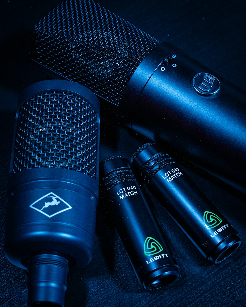 three microphones sitting next to each other on a table