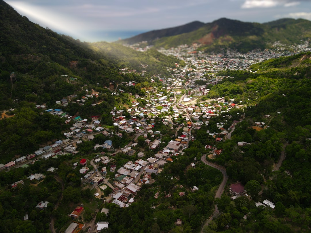 an aerial view of a small town in the mountains,