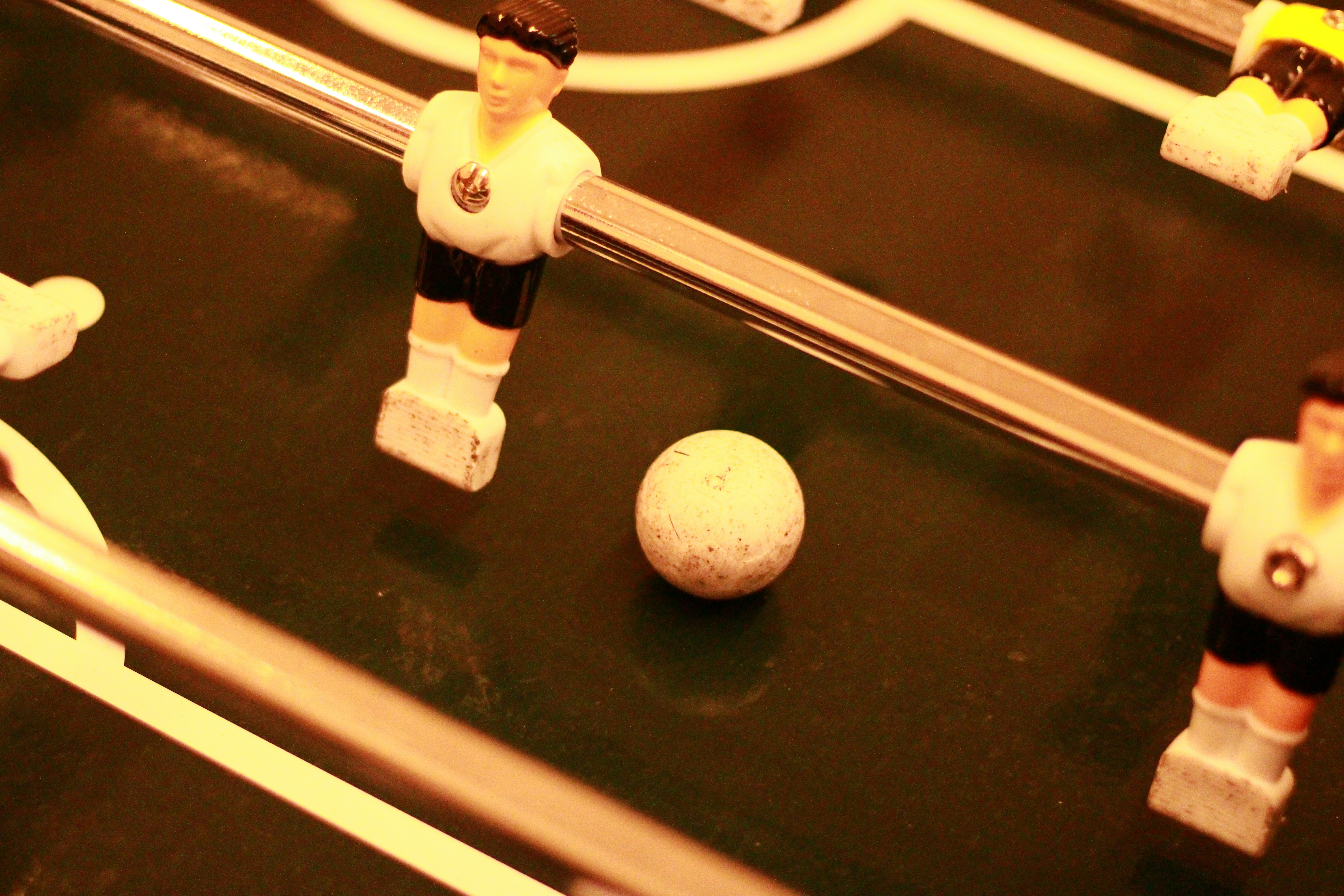 a group of figurines playing a game of foo - ball