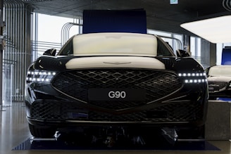 the front of a black car in a garage