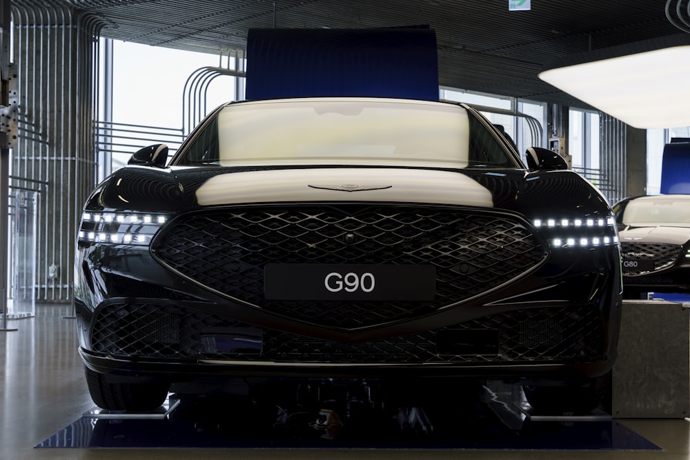 the front of a black car in a garage