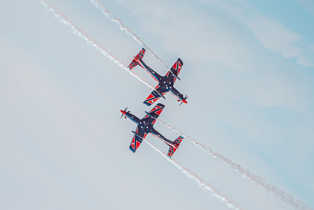 four red white and blue airplanes flying in formation