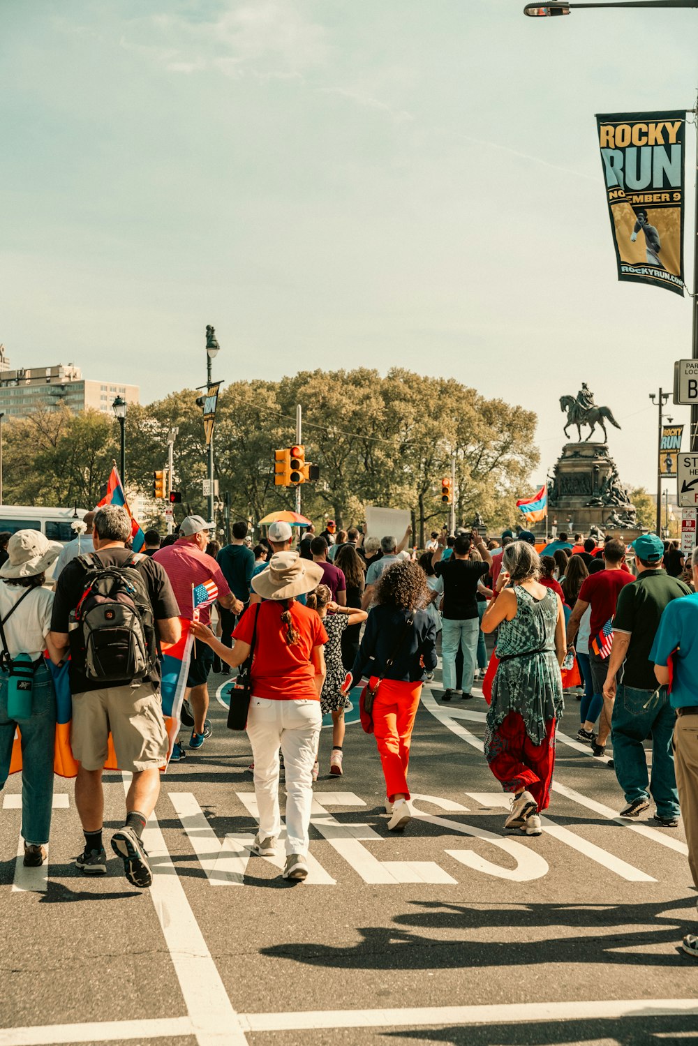 a group of people walking across a street