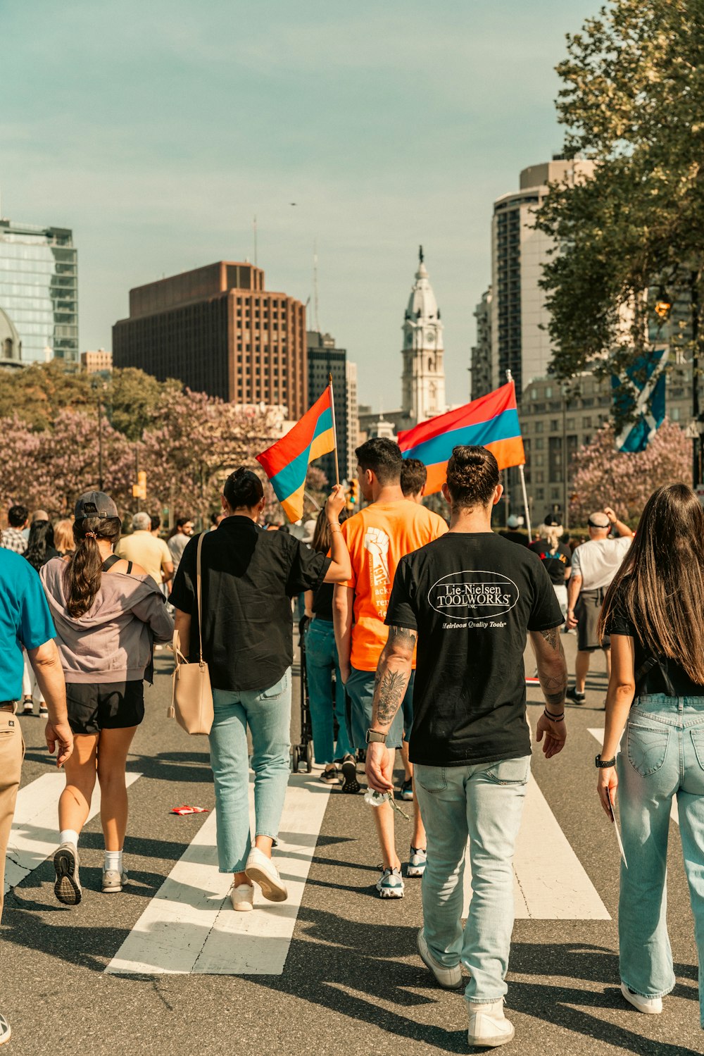 a group of people walking across a street