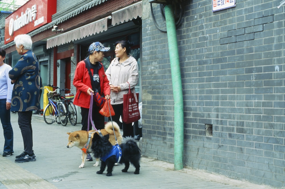 a group of people standing next to each other on a sidewalk