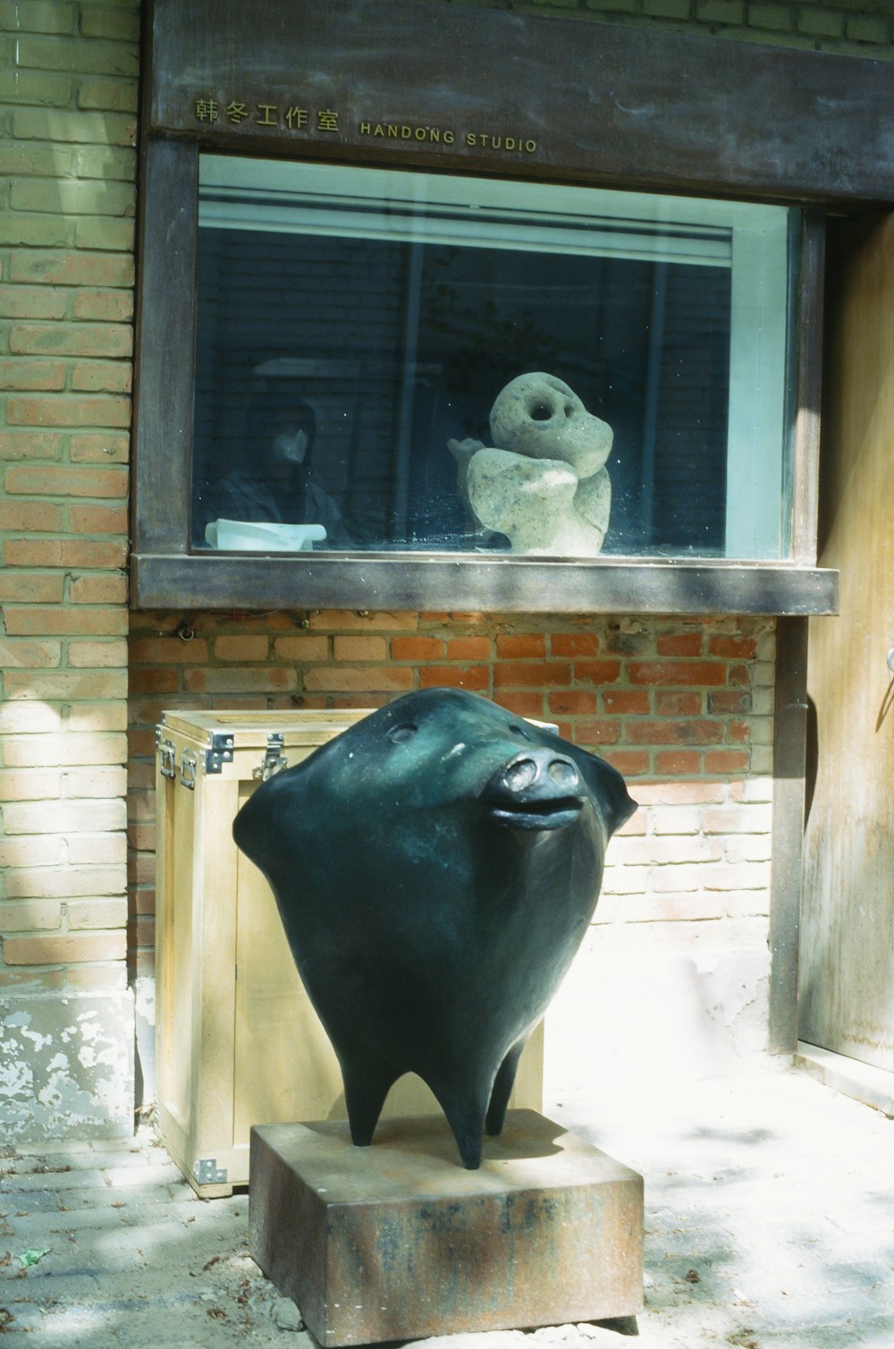 a sculpture of a fish in front of a window