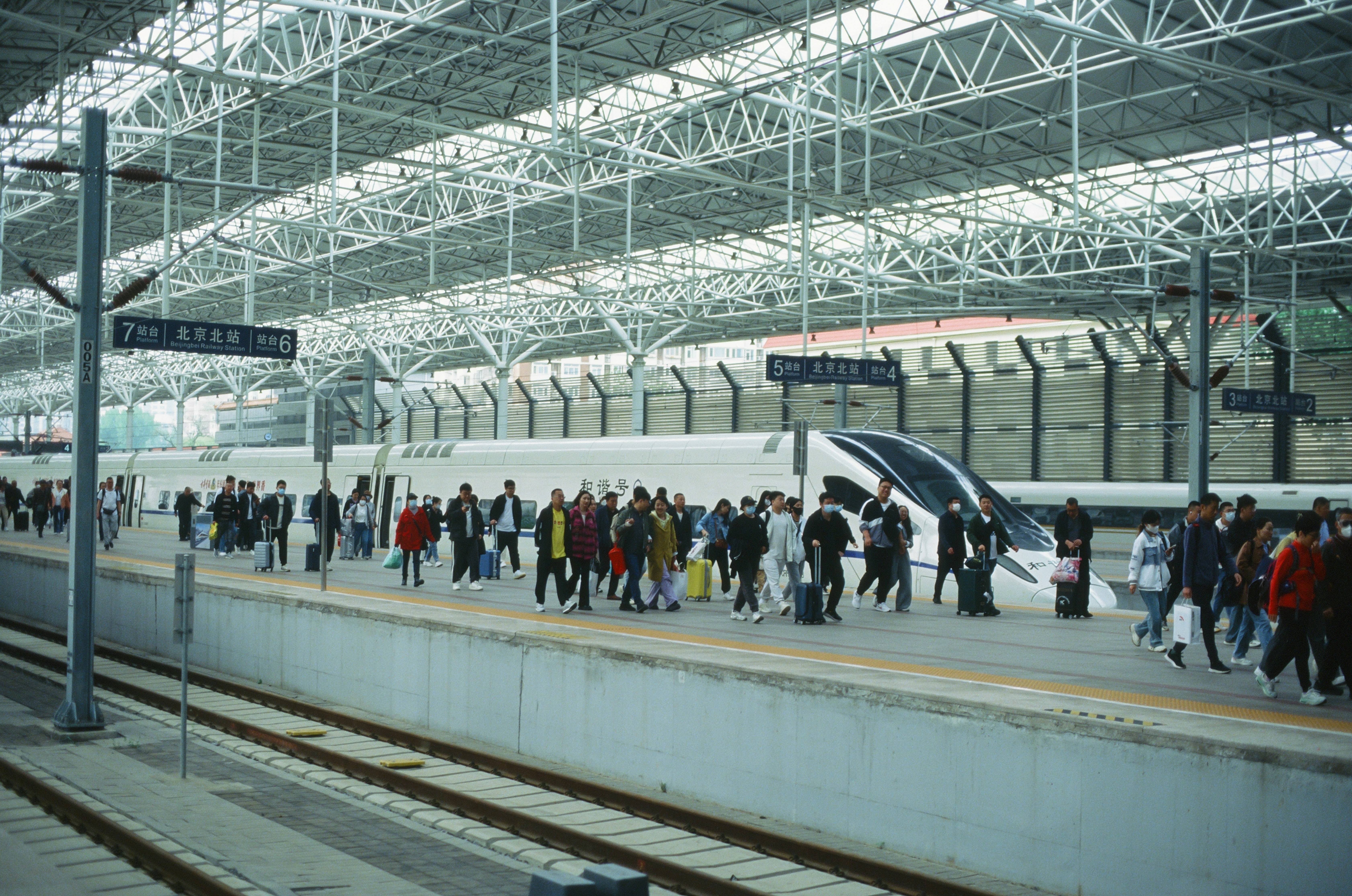 Engineers in a clean room facility inspecting a large metal structure, possibly a train car section, with advanced tools
