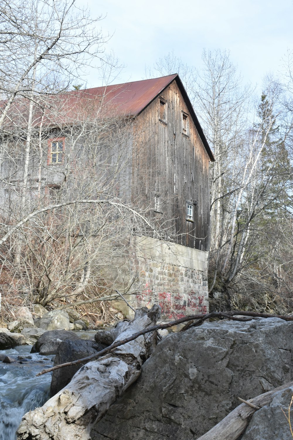 a large wooden building sitting next to a river