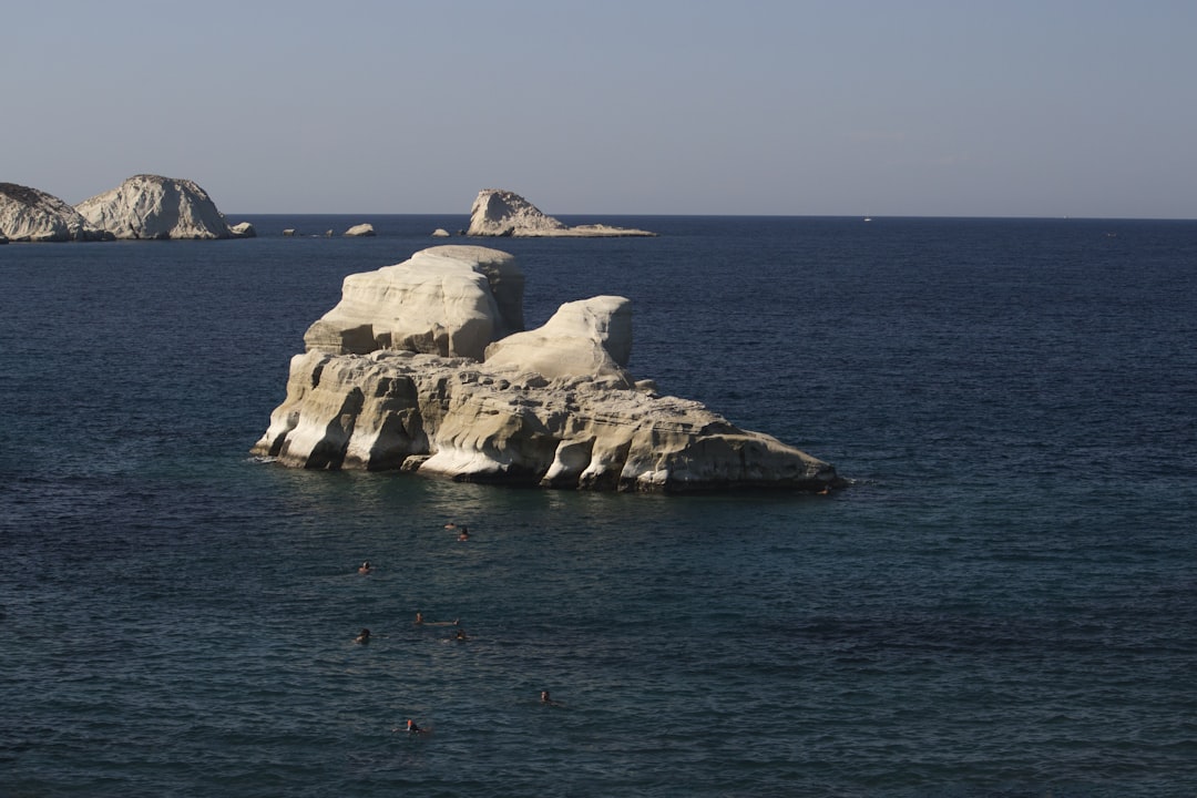 a body of water that has some rocks in it,