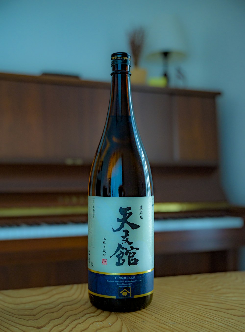 a bottle of wine sitting on top of a wooden table