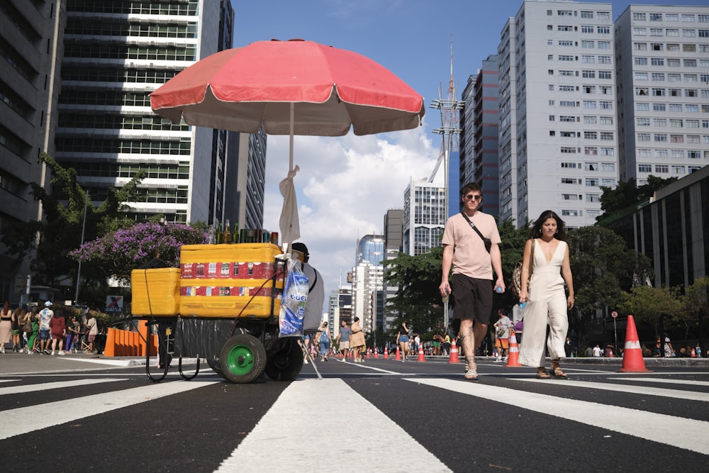 a man pushing a cart down a city street