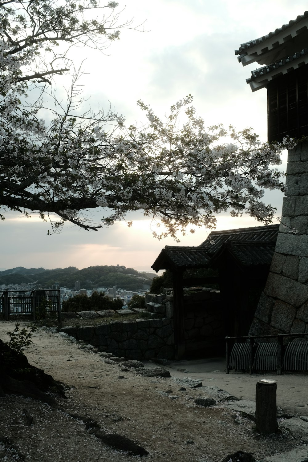 a stone building sitting next to a tree