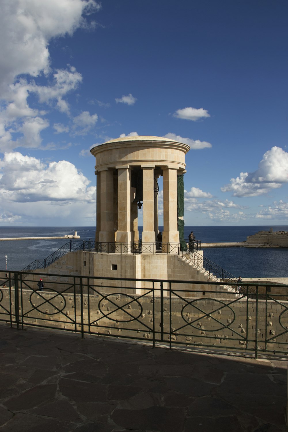 a stone monument with a bell on top of it