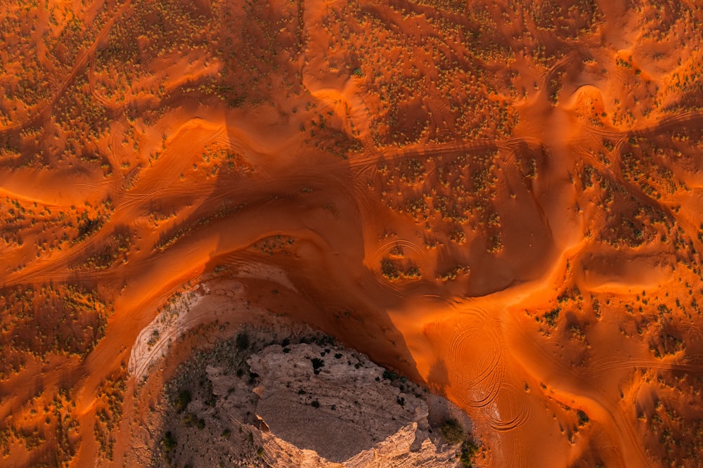 an aerial view of a sandy area with a river running through it