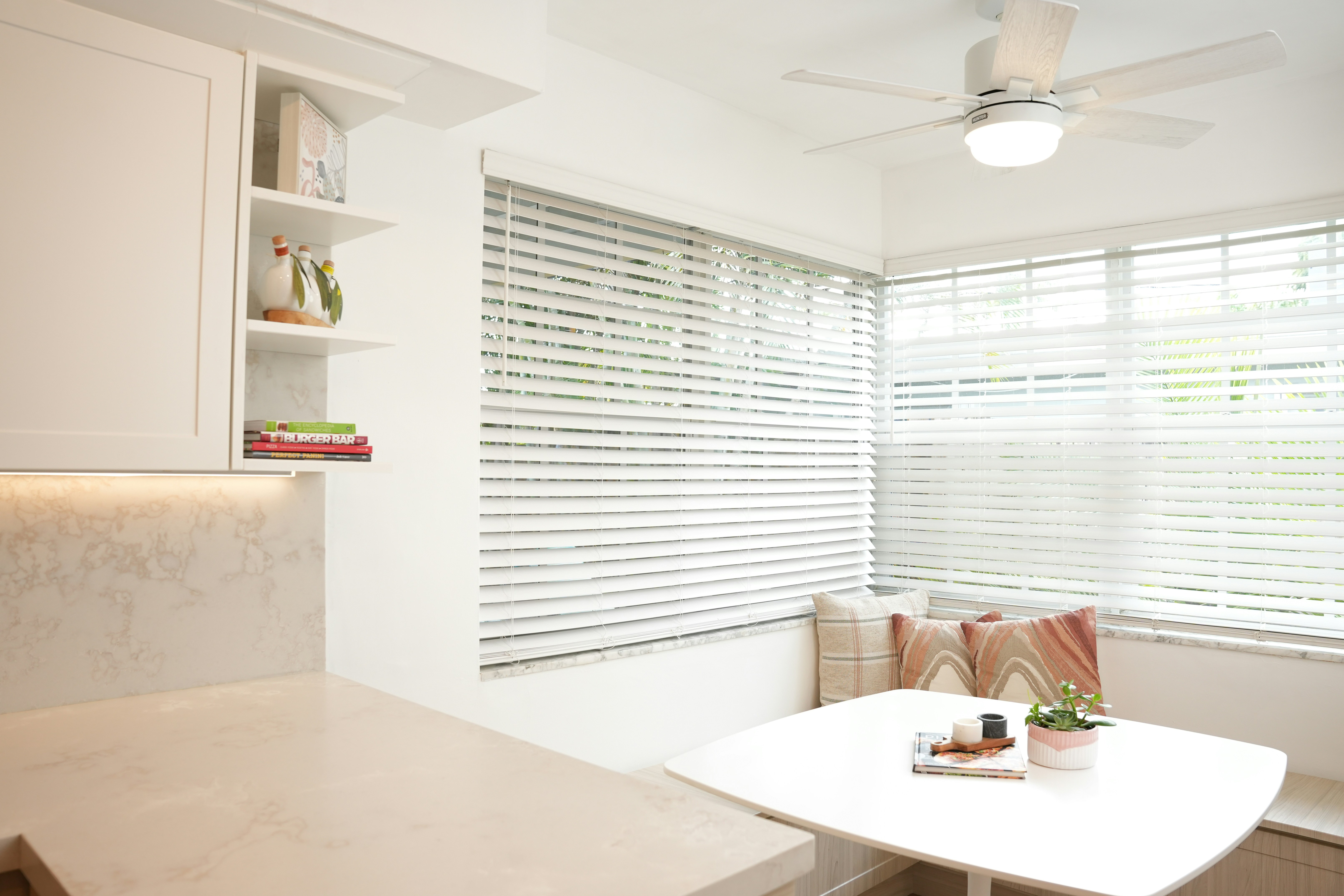 a kitchen with a white table and a white ceiling fan — stock photo by Kitchen Tune-Up Aventura on Unsplash