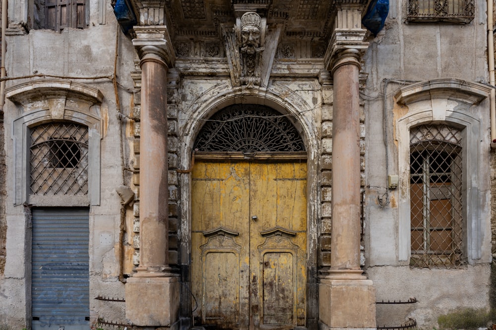 an old building with a large yellow door