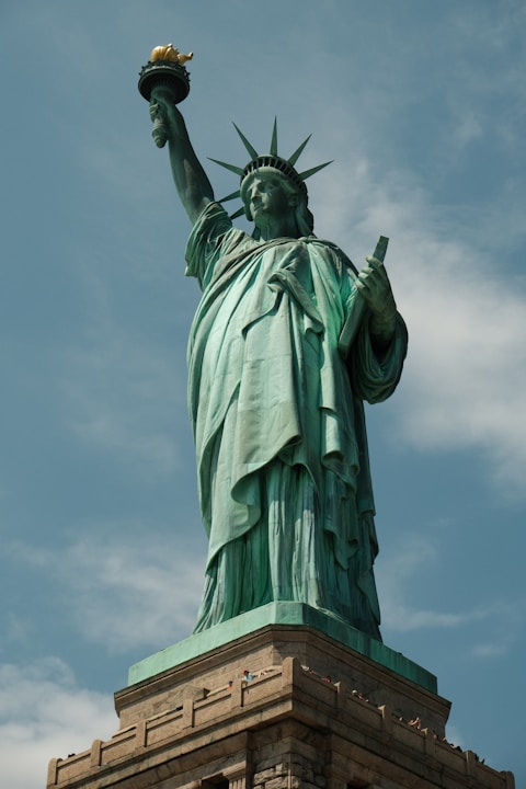 the statue of liberty is shown against a blue sky