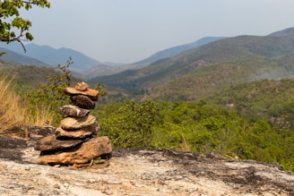 a stack of rocks sitting on top of a mountain