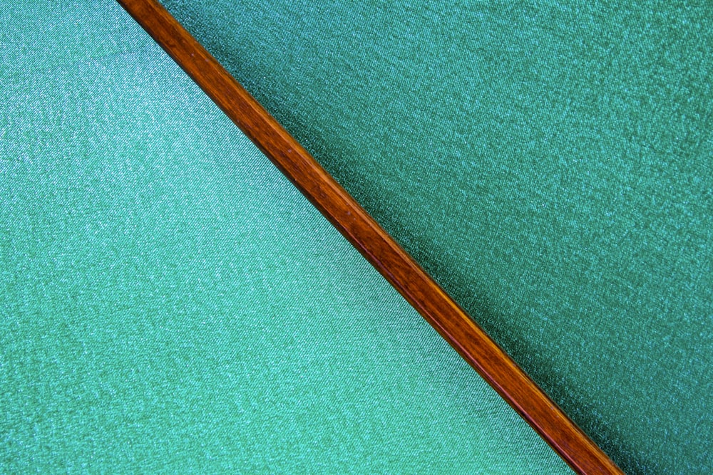 a close up of a pool cue laying on the ground