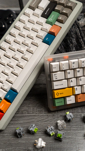 a couple of keyboards sitting on top of a wooden table