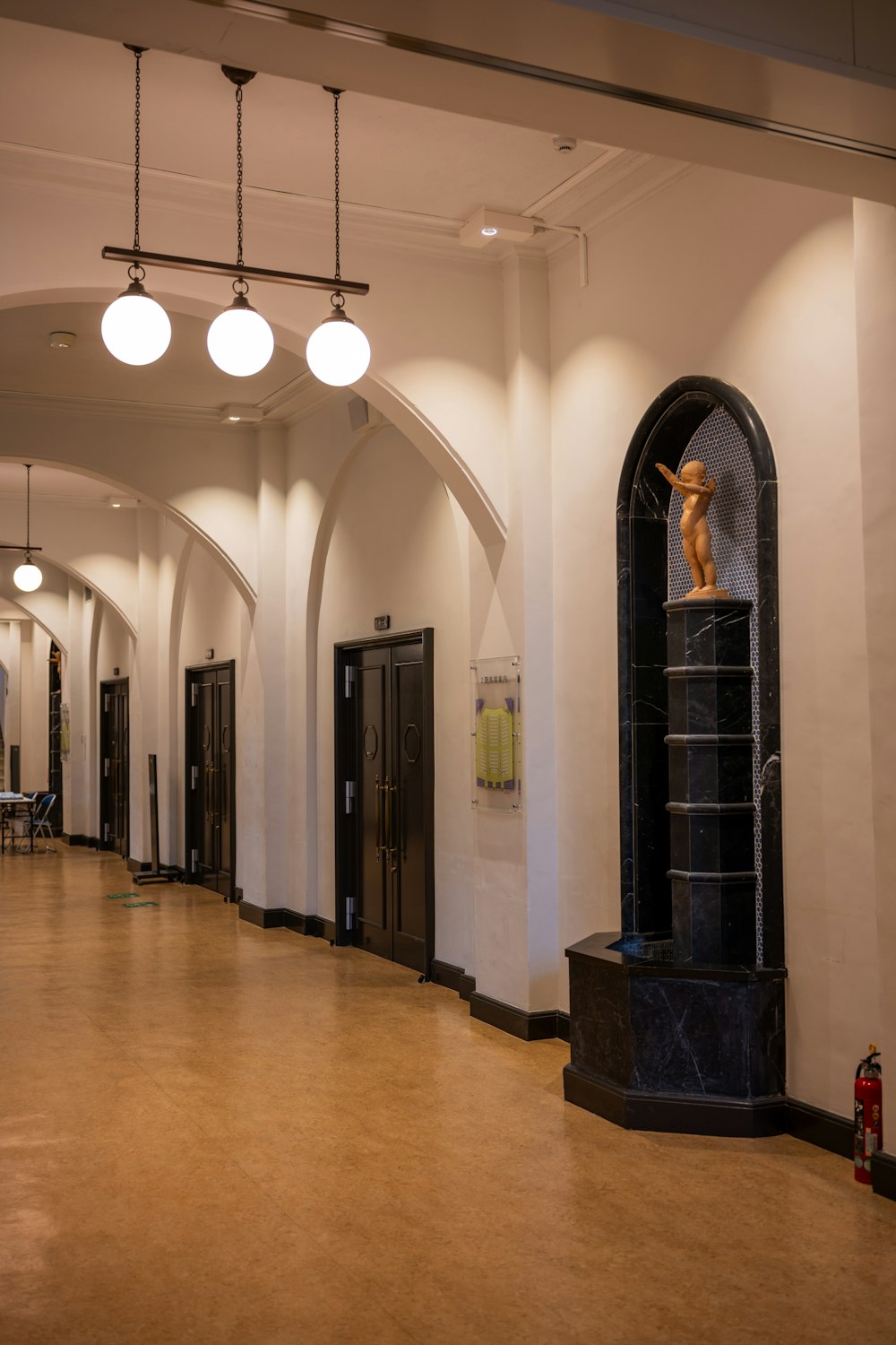 a long hallway with a clock on the wall